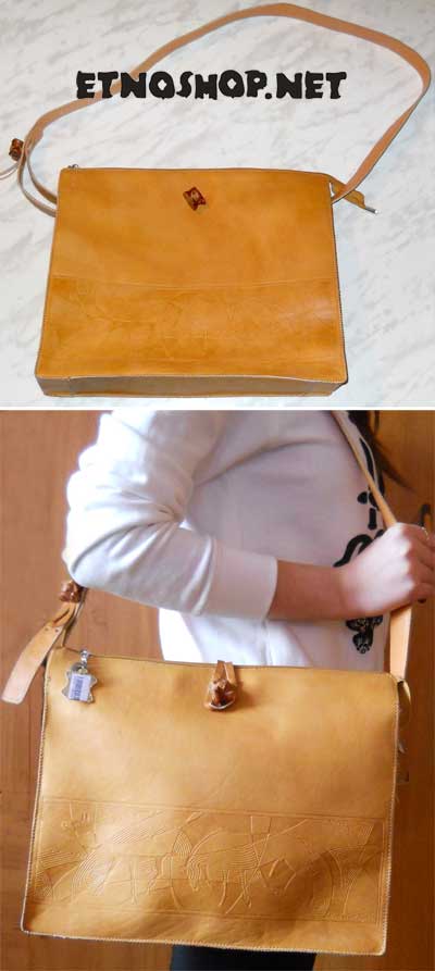 Женская сумочка ручной работы из кожи с тисненым рисунком изображающим лошадей.